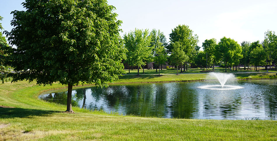 The Wisconsin Rapids Campus pond with water fountain.