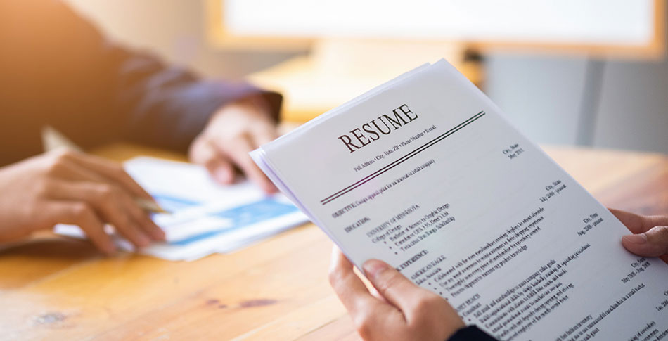 Person holding their resume.