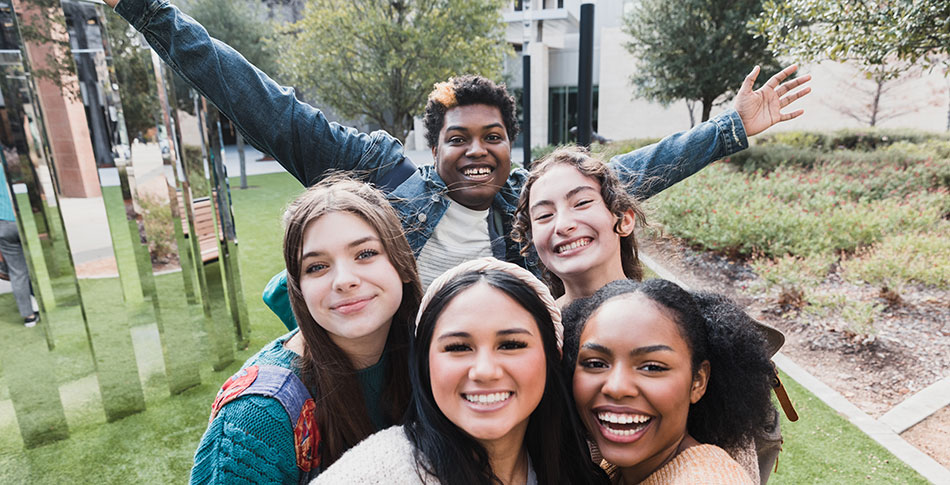 A group of high school students smiling at the camera.