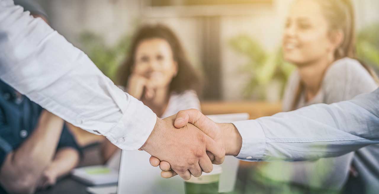 Hand shake at a table
