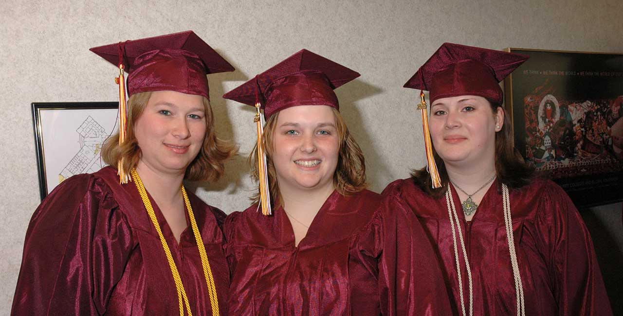 3 Women in MSTC graduation gowns