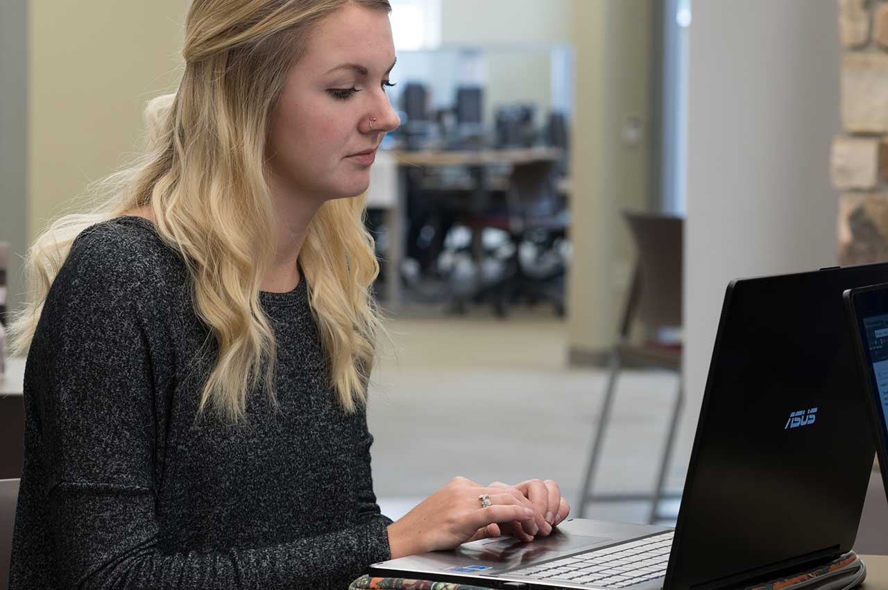 Woman studying with laptop