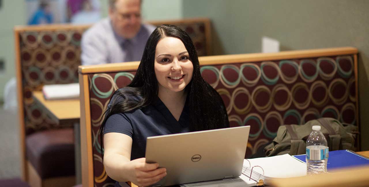 Woman studying with laptop