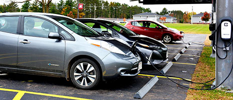 Electric vehicles sitting at solar powered electric charging station