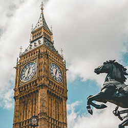 Top half of Big Ben Elizabeth Tower in London with horse from statue of Queen Boudicca in foreground - Photo by Jurica Koletić on Unsplash
