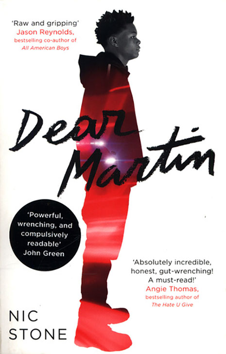 Book cover of Dear martin full body photograph of a man standing looking to the right
