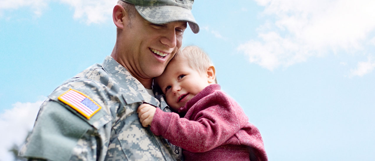 Man in uniform holding a child