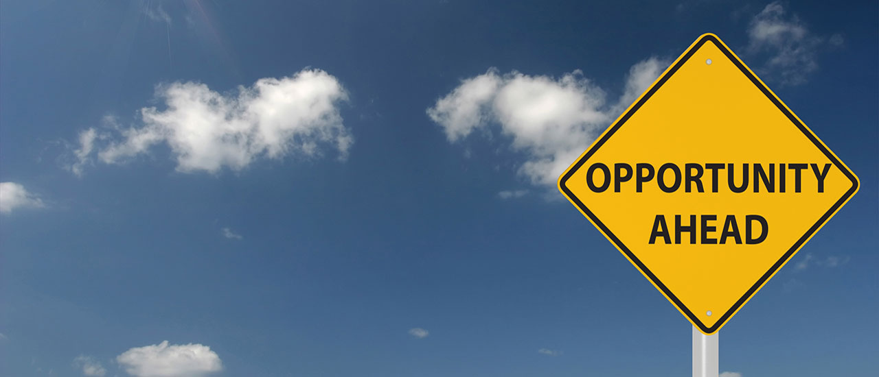 Sky in background, sign saying "opportunity ahead" on the right.