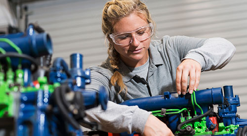 woman working with a diesel engine