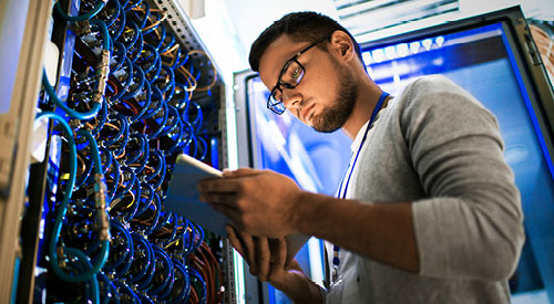 IT Cybersecurity Specialist working in a data closet