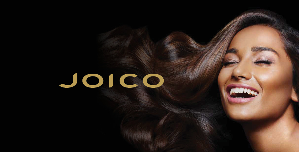 Woman smiling with hair flowing outward to the left with the Joico logo next to her.