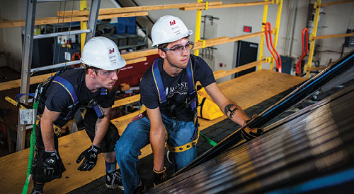 2 Mid-State students working on a solar powered roof exercise