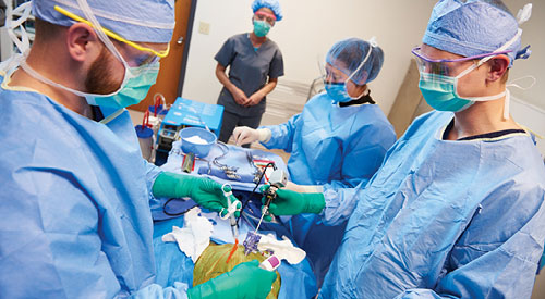 Several surgeons working on a patient