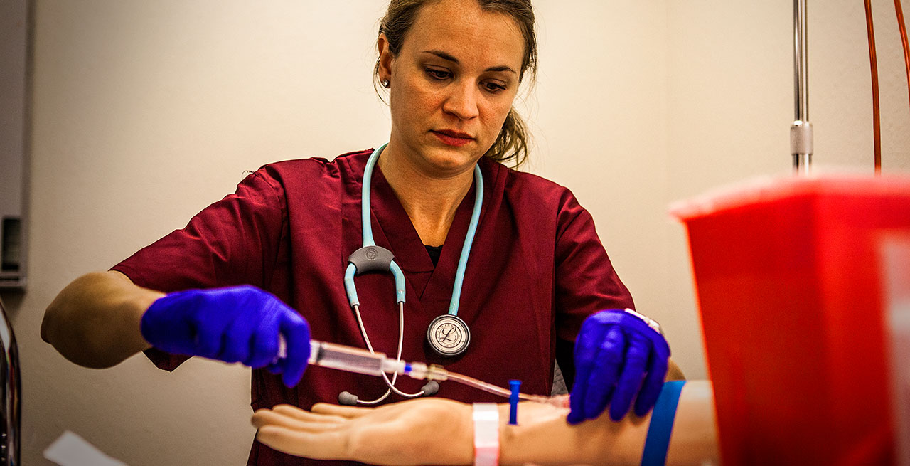 Nurse practicing on a dummy