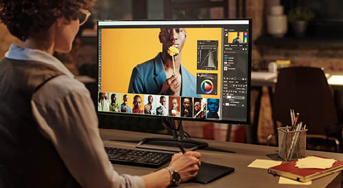person working in an adobe program on a computer