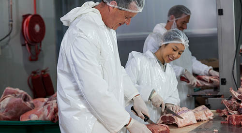People cutting and preparing meat