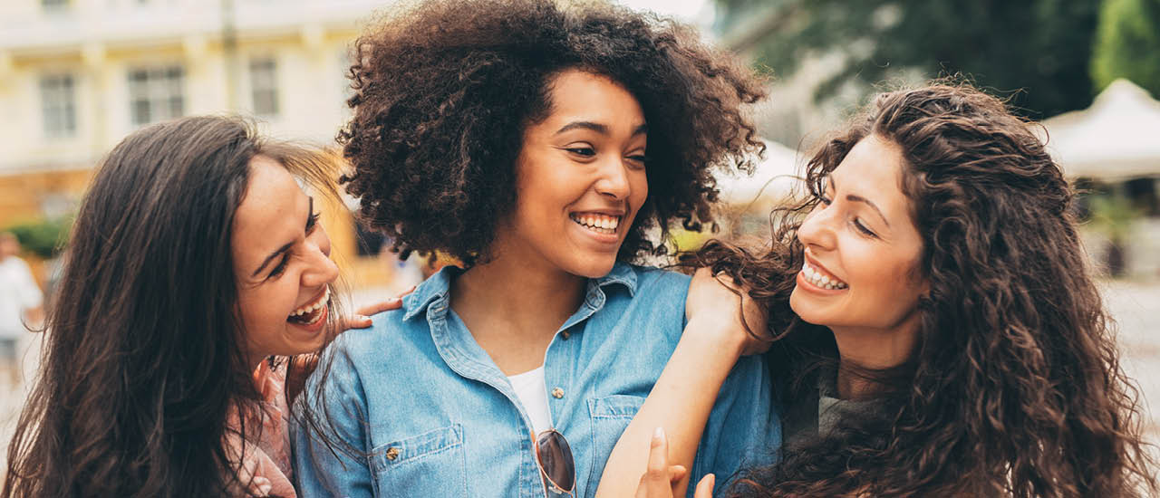 3 people standing next to each other smiling