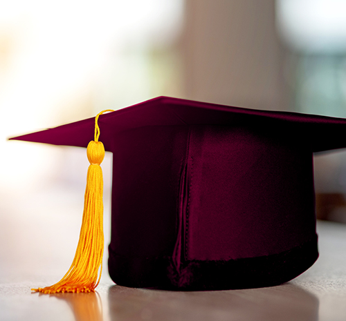 Maroon Graduation cap with yellow tassle