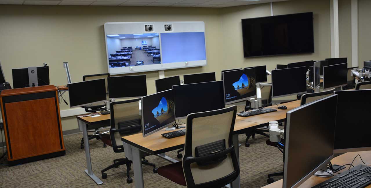 computer lab with large screens at front of the room