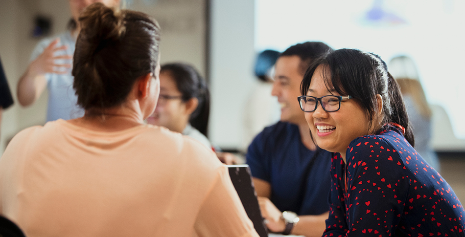 People sitting around a conference table conversing