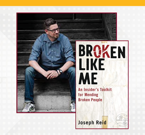 Joe Reid sits on the steps with his book cover of "Broken Like Me."