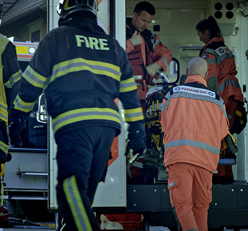 several people dressed in fire and paramedic gear