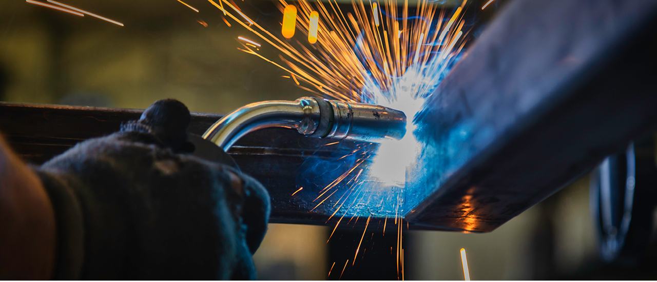 Person welds two beams together.