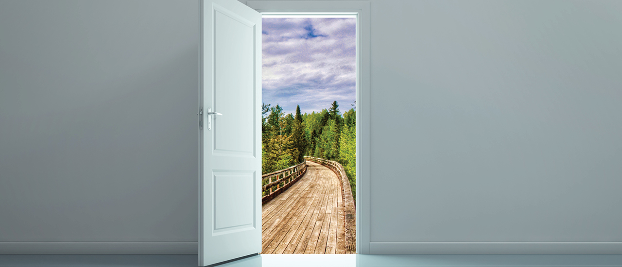 Door opens onto a bridge leading off into the distance.