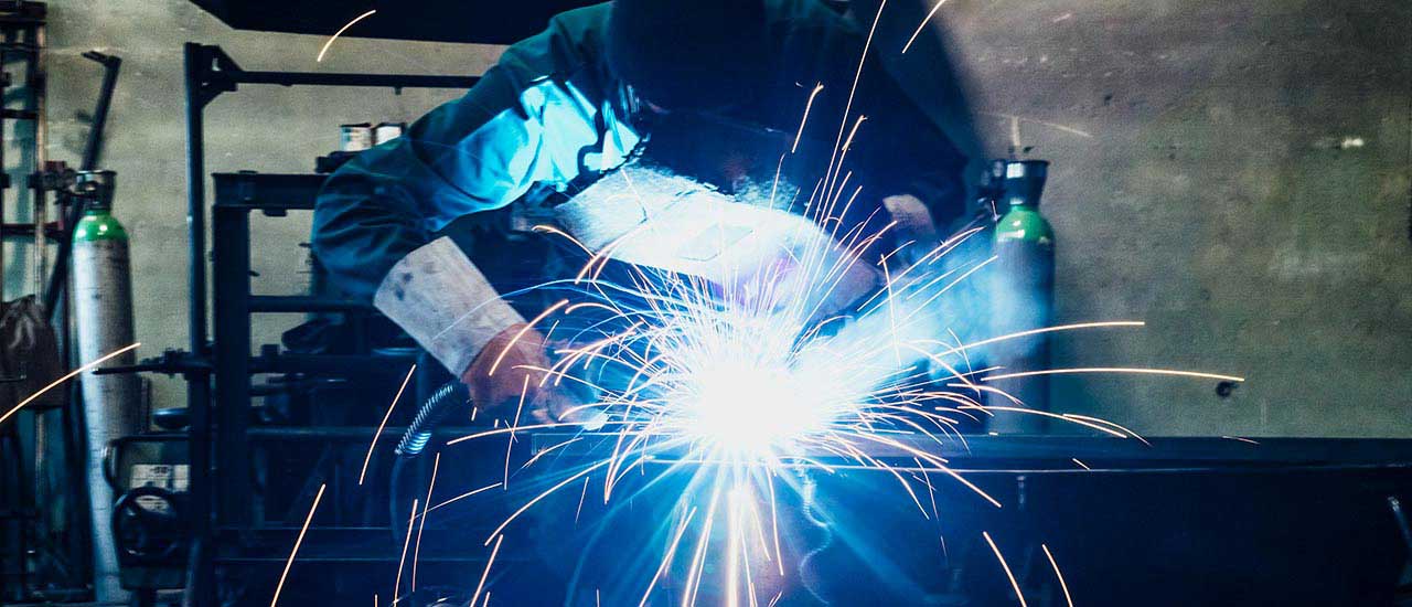 Ironworker welding, sparks flying