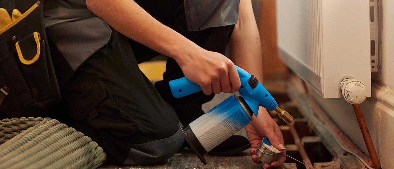 Plumber working on a radiator