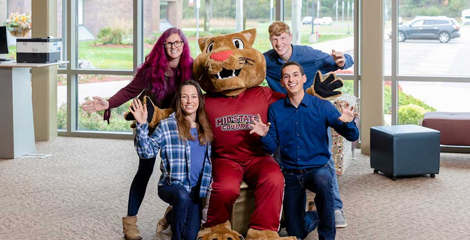 Students posing with Mid-State Mascot Grit