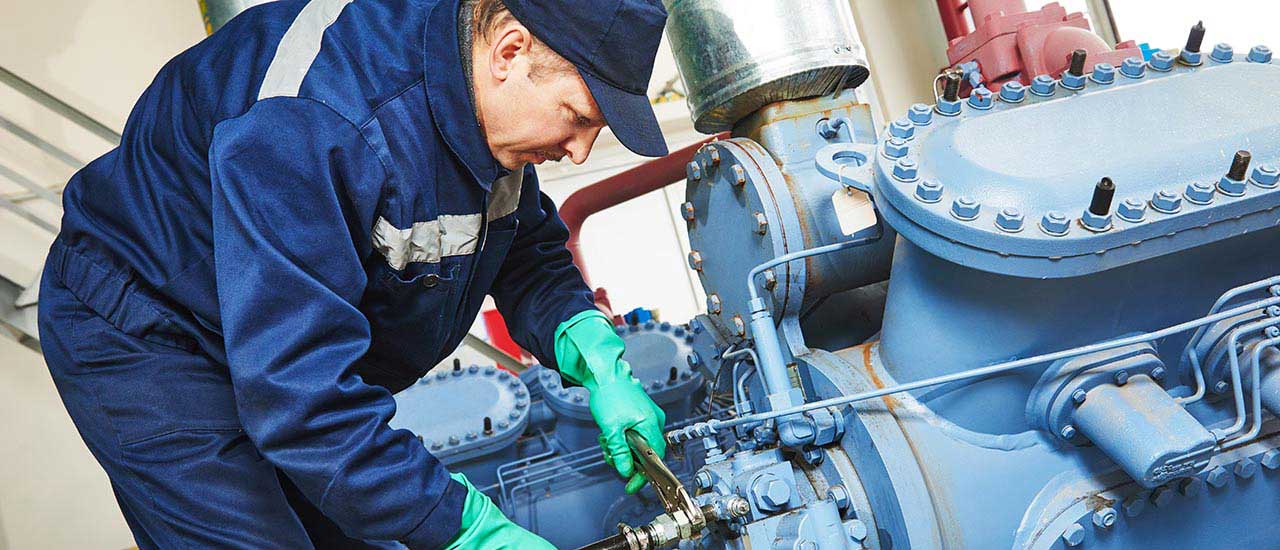 Steamfitter working on machine