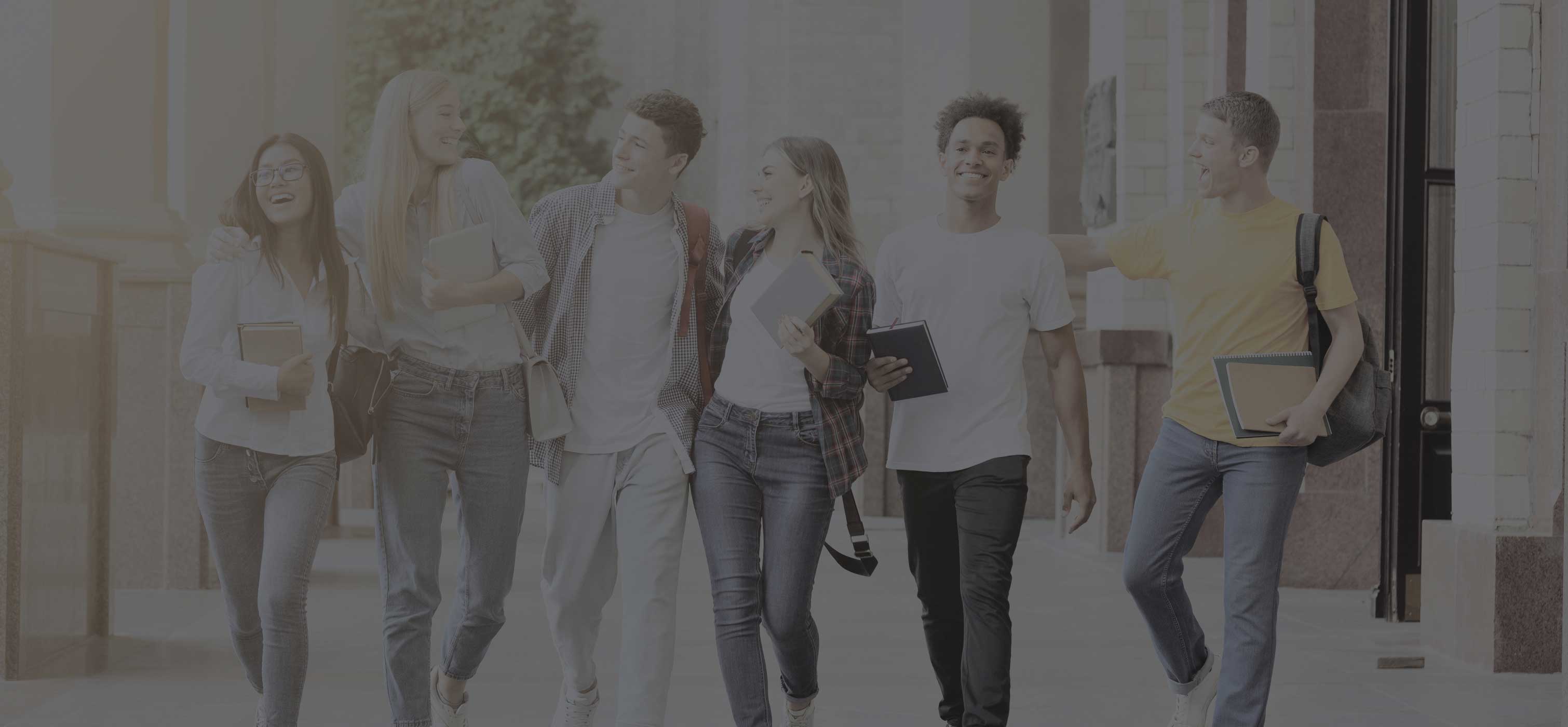 People walking holding books, notebooks, and backpacks