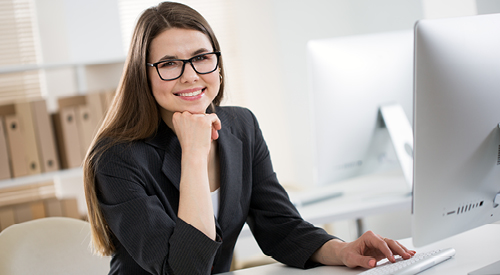 Person sitting in front of a computer looking at the camera