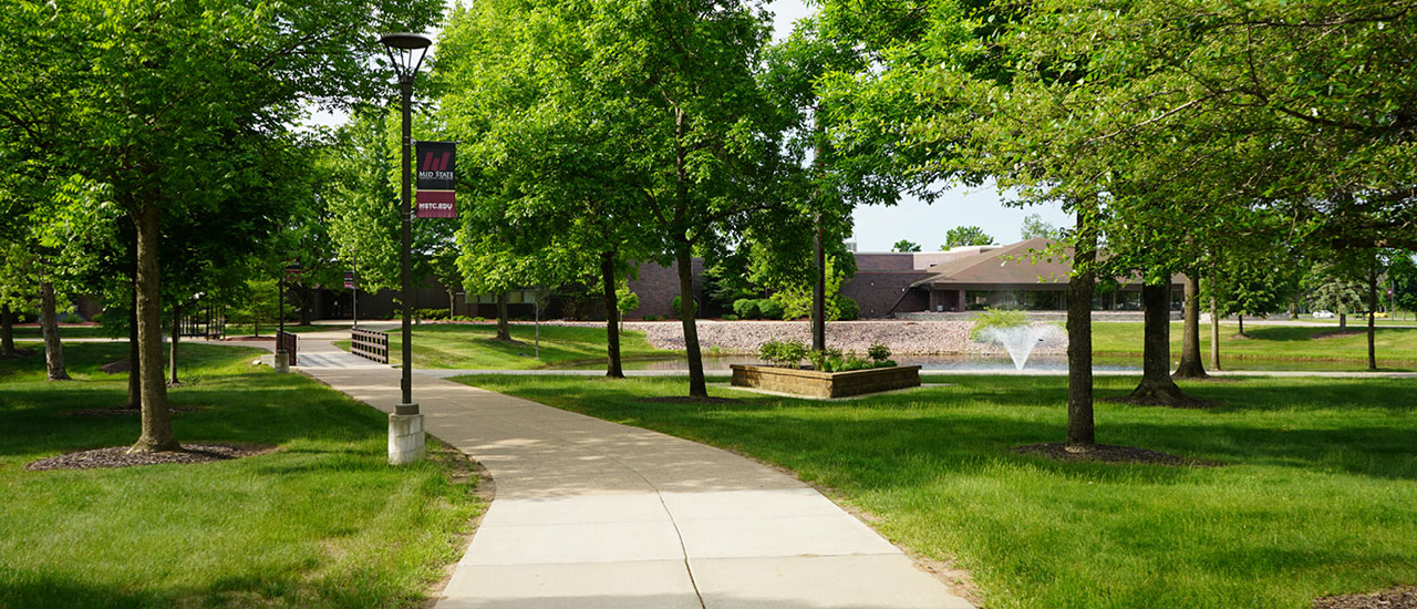 The Wisconsin Rapids campus walking path, bridge, and pond.