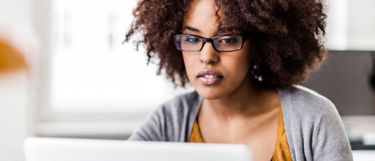 Woman working on a laptop.