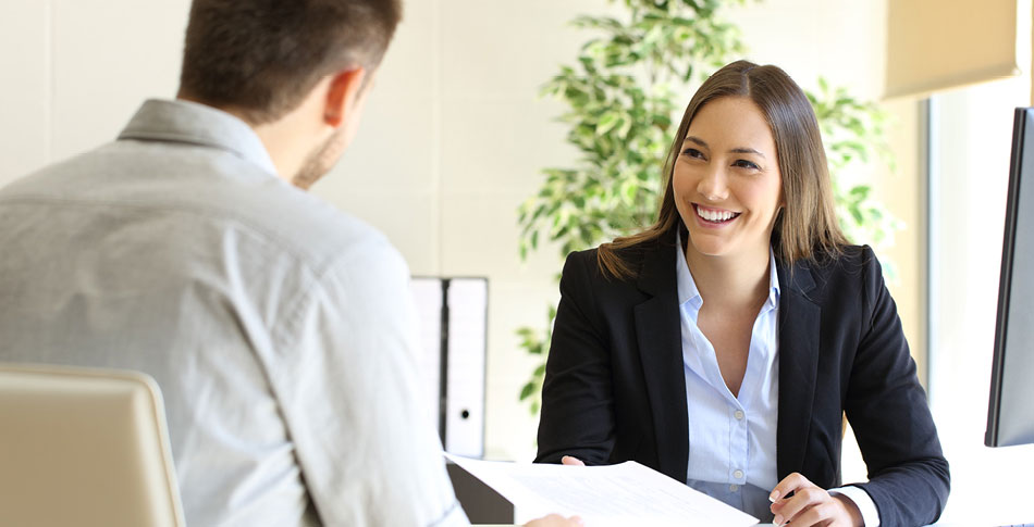 Woman smiling as she is interviewed.