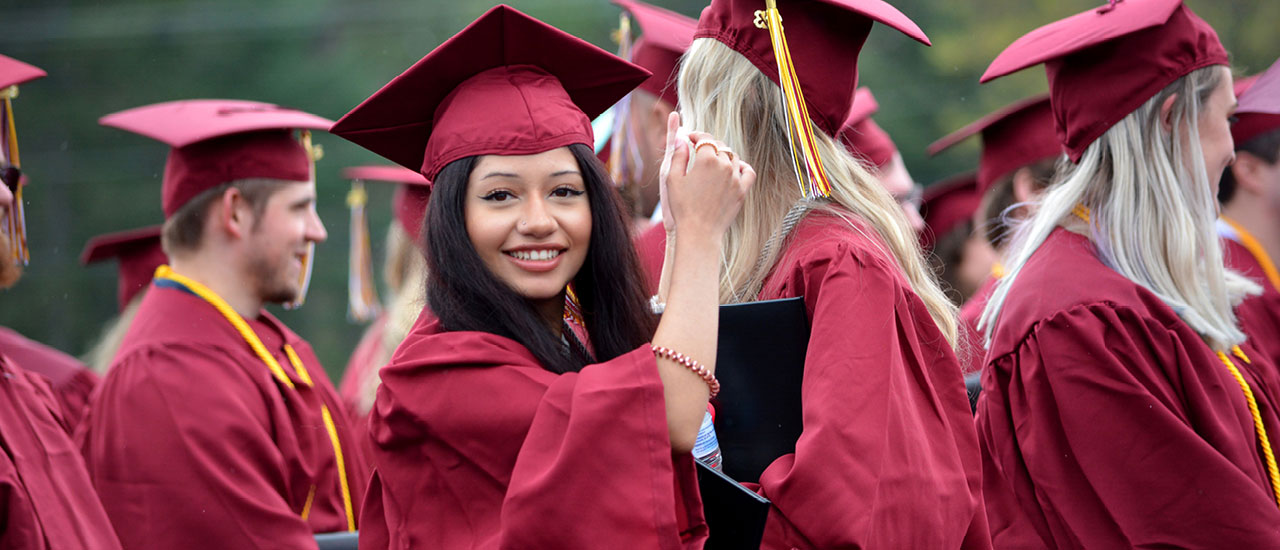 Student at Mid-State's graduation in cap and gown.