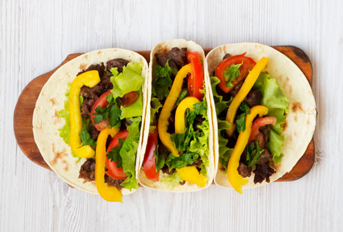 3 tacos on a cutting board