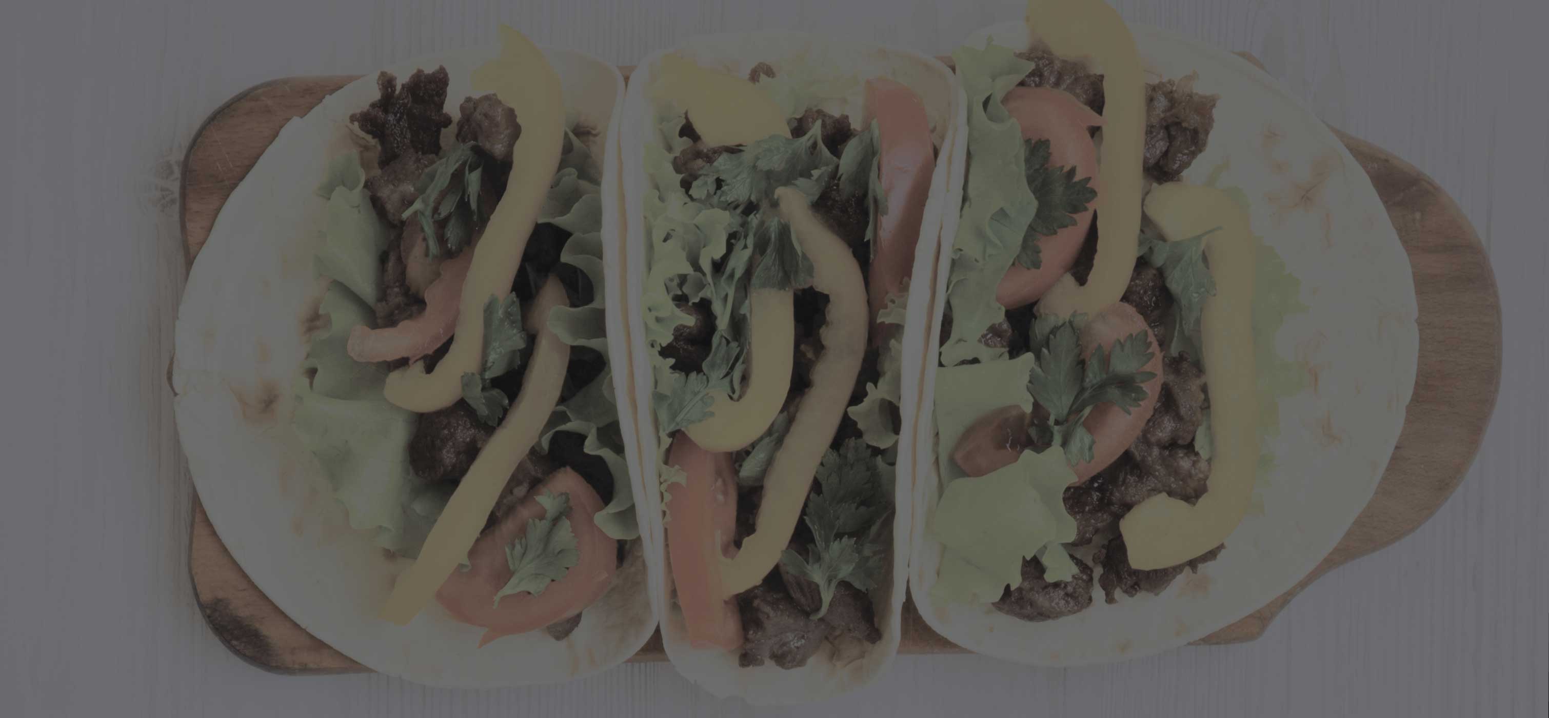 3 tacos on a cutting board