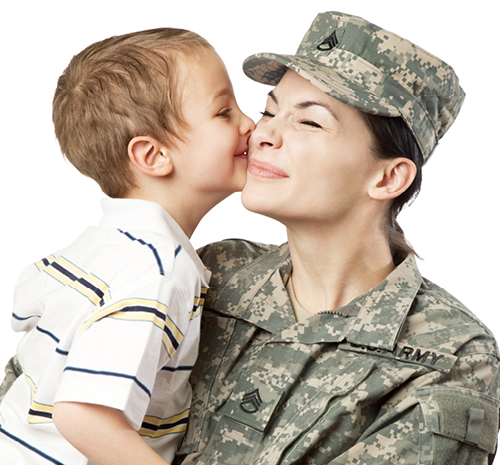 Kid kissing person in an army uniform on the cheek
