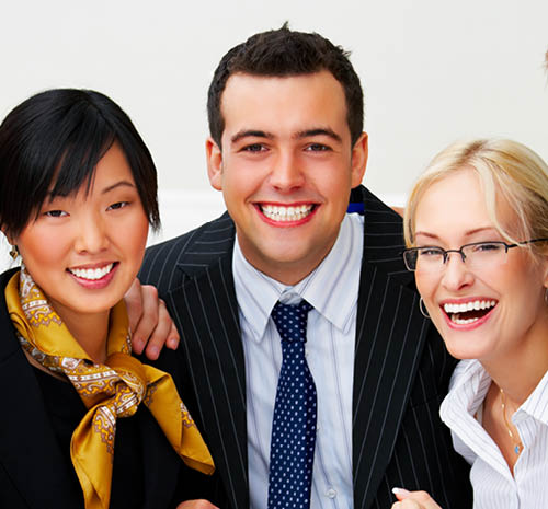 3 people smiling at the camera dressed in business attire