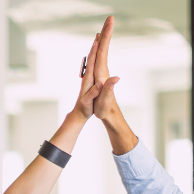 Two hands raised in a high-five.