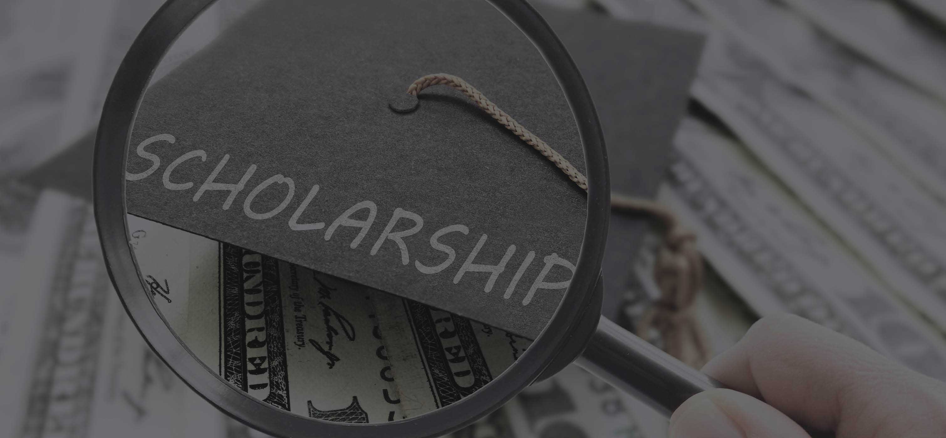 Magnifying glass over a graduation cap that says "scholarship" money in the background