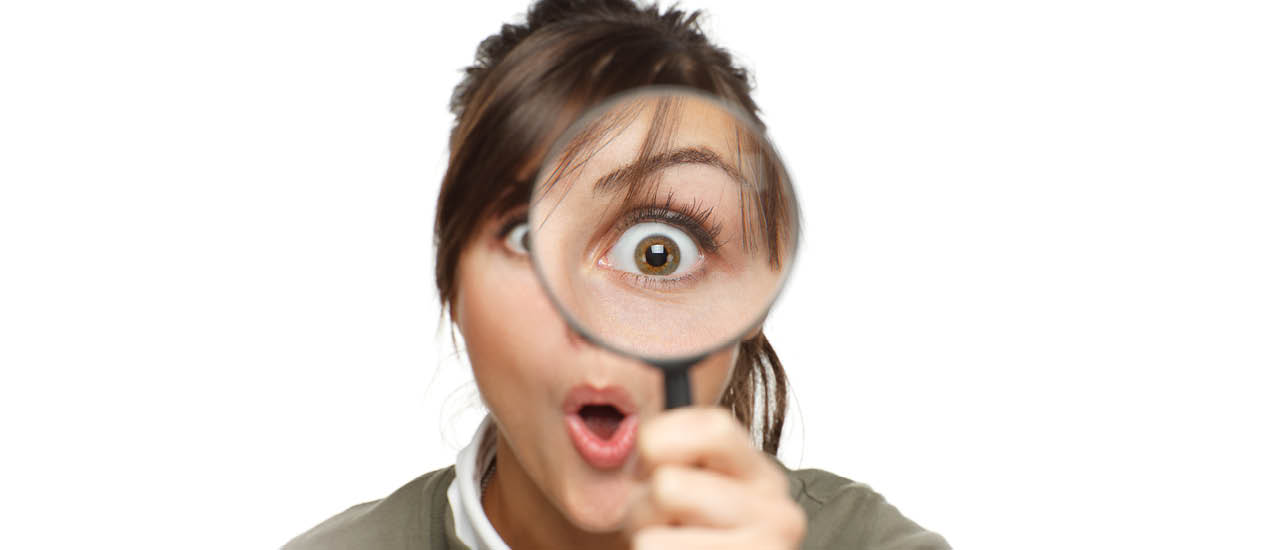 Person looking through a magnifying glass.