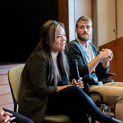 Person speaking on a panel.