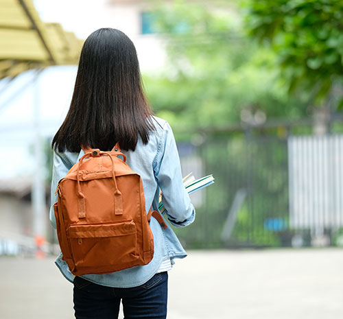 Person looking away from the camera with a backpack on.
