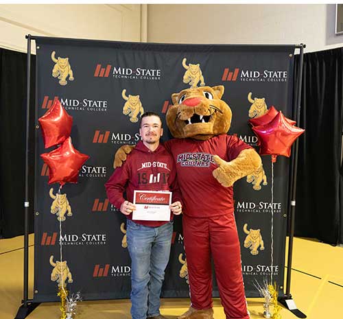 Admit Day 2025 attendee with Mid-State's mascot, Grit.