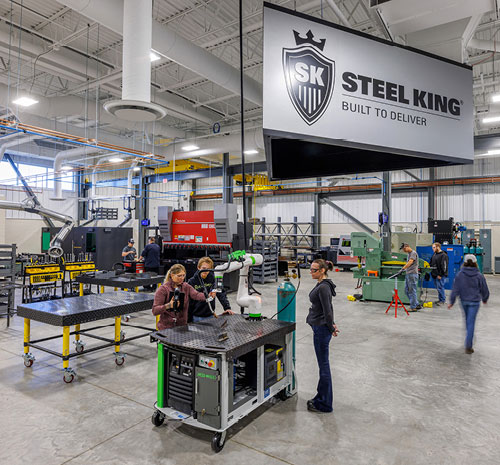 Room inside of the AMETA™ Center with students working with machinery