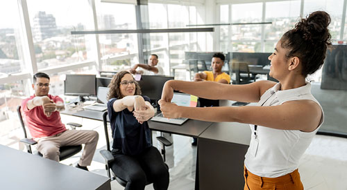 A group of poeple doing hand stretches